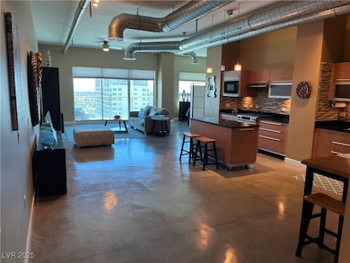 Kitchen featuring dark countertops, decorative bac
