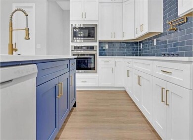 Kitchen with appliances with stainless steel finis