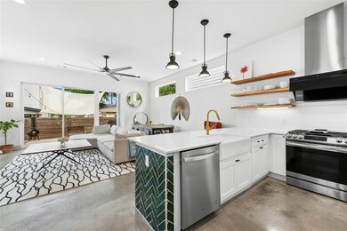 Kitchen with concrete flooring, ceiling fan, a si