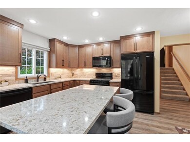 The kitchen features custom cabinets, Cambria quar