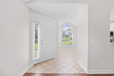 Foyer featuring a chandelier and light tile patterned floors