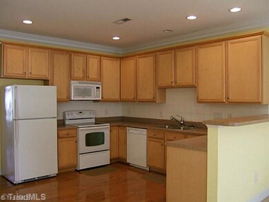 Kitchen. New dishwasher, lots of counter space, breakfast bar, hardwood floor, ceramic tile backsplash, and pantry.