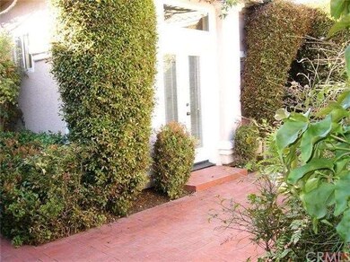 Master bedroom opens to small shared patio with ca
