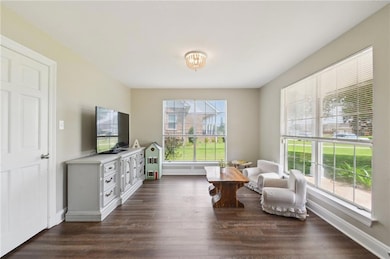 Den or playroom with access to the kitchen