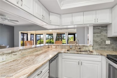 Kitchen with white cabinets, stainless steel dishw