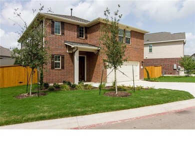 Traditional home with concrete driveway, brick si