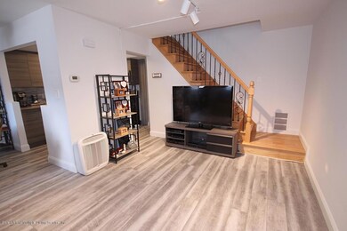 living room w.newer floors and staircase