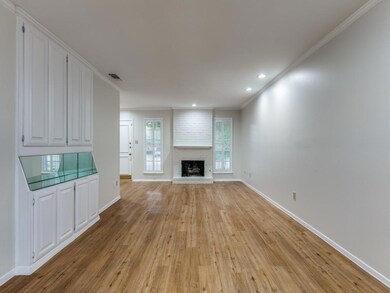 The living room includes a brick fireplace with ga