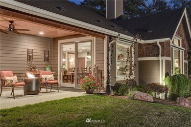 Covered outdoor living room provides the perfect gathering space for year round entertaining. Enjoy a warm fire outdoors while overlooking the private back yard and meadow. 