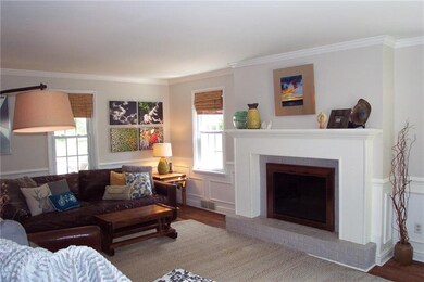 Living room is offers lots of light, wood burning 