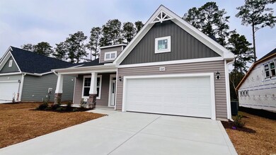 Craftsman-style home with a garage and covered por