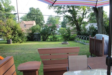 View of the large yard w/ fire pit