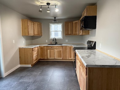 Kitchen featuring black appliances and light countertops