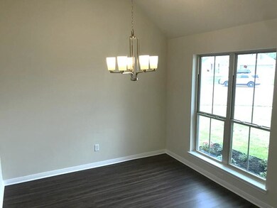 Spare room featuring an inviting chandelier, baseb