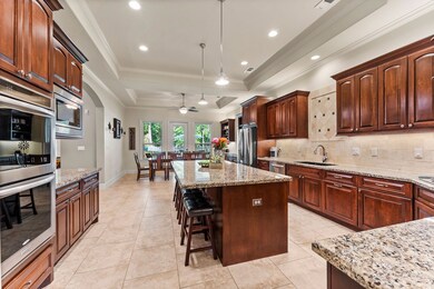 The Kitchen is massive. The island is 8' x 4' alone! Double ovens, Gas Range, under-and-over cabinet lighting, and more.