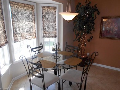 Breakfast area sits in a bay window looking over the backyard and patio