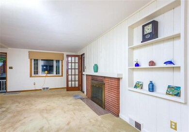 Living room has a fireplace and exits to the priva