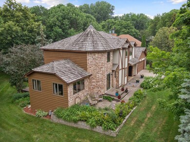 Beautiful stone, cedar, and stucco siding with a cedar shake roof.
