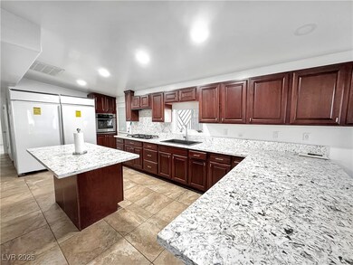 Kitchen with visible vents, a center island, light