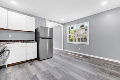 Kitchen with freestanding refrigerator, light wood