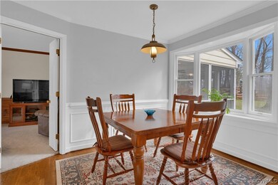 Carpeted dining area with ornamental molding