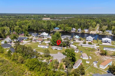 Aerial view with a wooded view, a residential view, and a water view