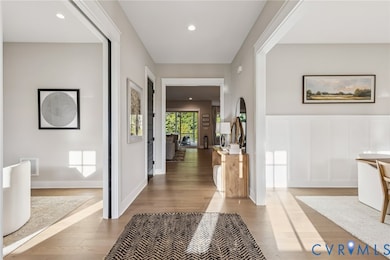 Hall with recessed lighting and wood finished floors