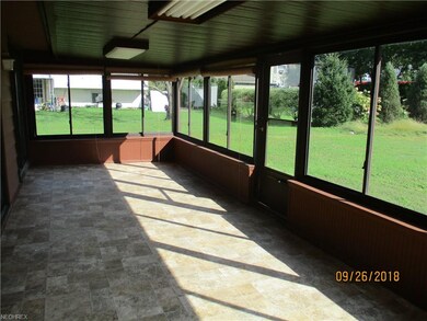 The enclosed porch is large enough for a summer ro