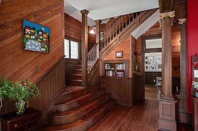Staircase with decorative columns, wooden walls, 