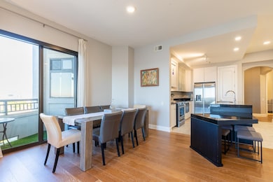 Dining space featuring sink and light hardwood / w