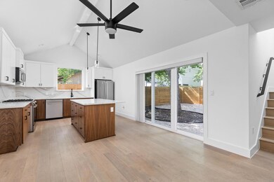 Kitchen featuring a ceiling fan, a center island,