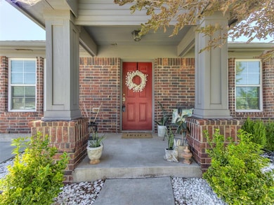 View of exterior entry featuring a porch and brick siding