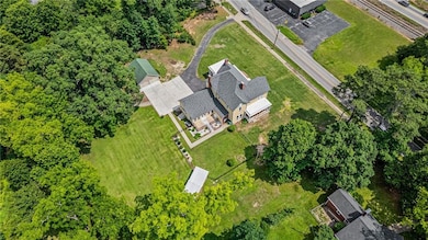 Fenced side yard, detached garage, pavilion, and a beautiful backyard
