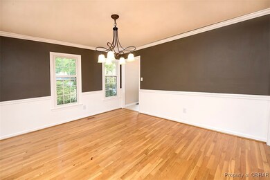 Empty room with an inviting chandelier, light hard