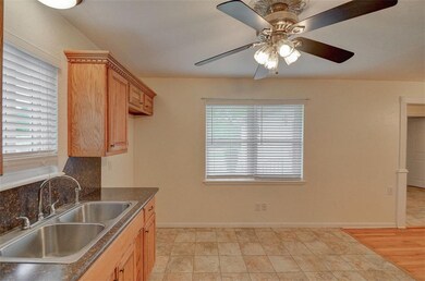 Kitchen has a ceiling fan and room for a small tab