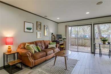 Living area with crown molding, wood finished flo