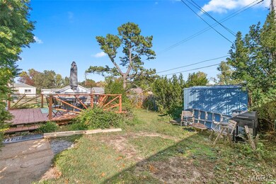 View of yard with a deck and a storage shed