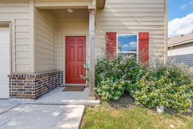 Property entrance with a garage and brick siding