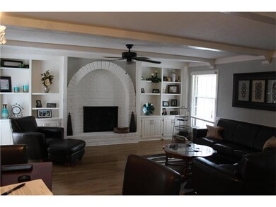 Built-in Bookshelves around the brick-lined firepl