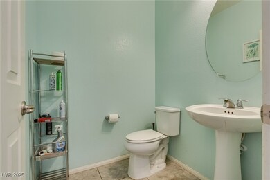 Half bath featuring toilet and tile patterned floo