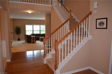 Entry looking towards den with steps leading to bedrooms and second floor