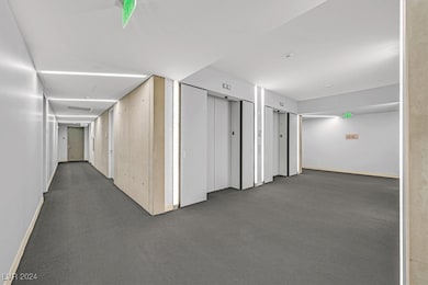 Corridor featuring elevator and carpet