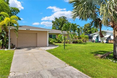 Single story home featuring a garage and a front lawn