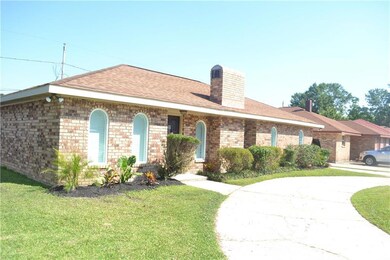 Left side of home with circular driveway and anoth
