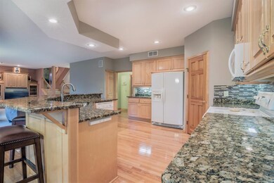 Kitchen features ample maple cabinetry, granite co