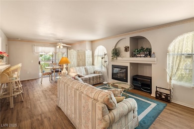 Living room featuring a glass covered fireplace, w