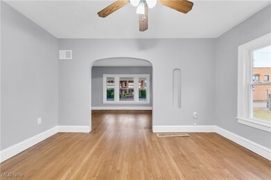 Unfurnished room featuring ceiling fan and light hardwood / wood-style flooring