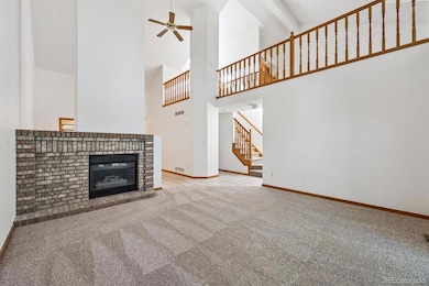 Inviting living room featuring brand new carpet, a cozy fireplace, vaulted ceilings, and private back patio