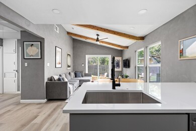 Kitchen with light wood-style floors, recessed li
