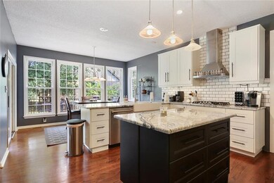 Large Eat in Kitchen with hardwoods that walks out
